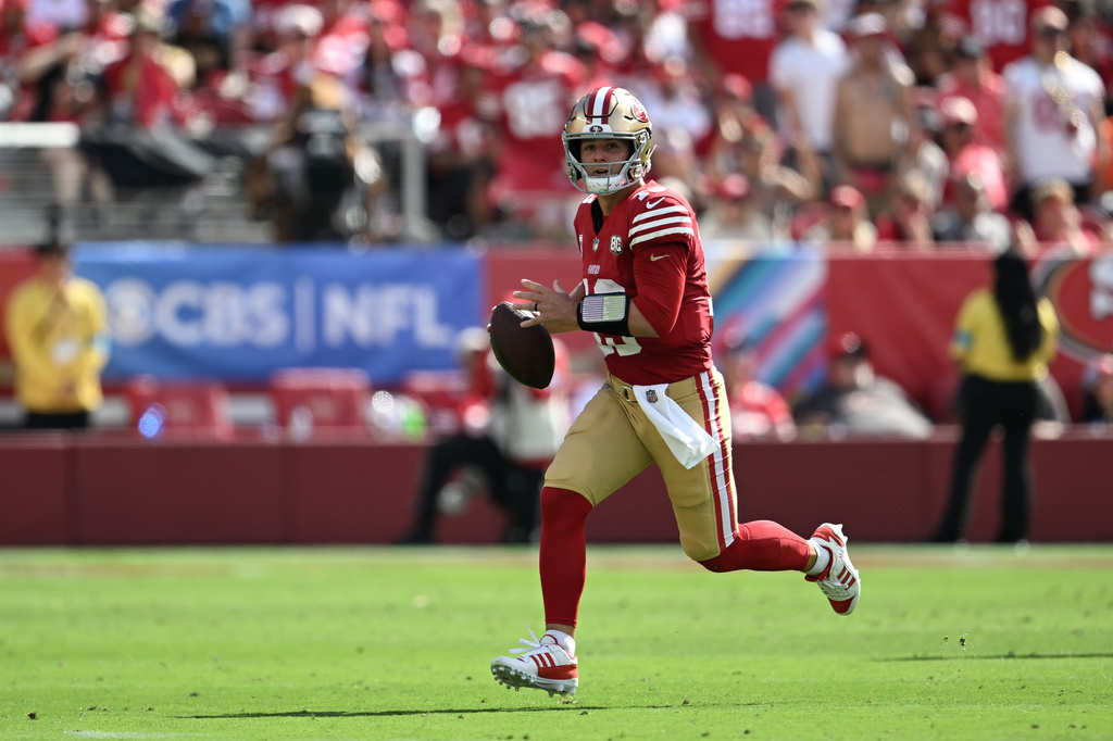 San Francisco 49ers quarterback Brock Purdy (13) rolls out during the first half of an NFL football game against the Denver Broncos in Santa Clara, Calif., Sunday, Oct. 4, 2026. (AP Photo/Justine Willard)