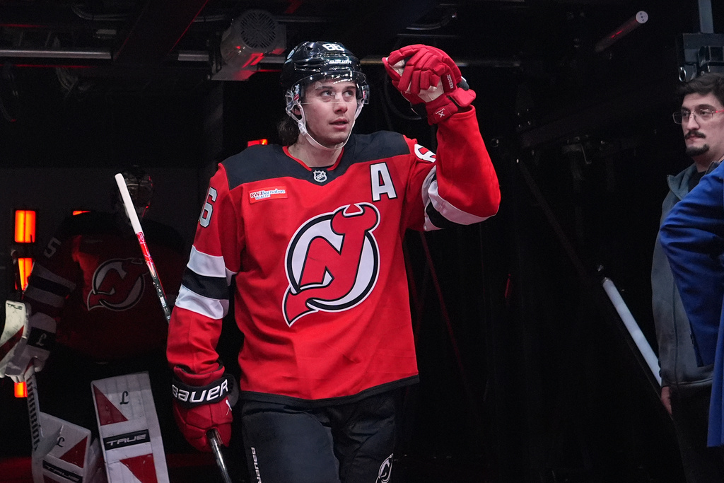 New Jersey Devils' Jack Hughes (86) walks toward the ice to warm up before an NHL hockey game against the Buffalo Sabres Wednesday, Feb. 25, 2026, in Newark, N.J. (AP Photo/Frank Franklin II)