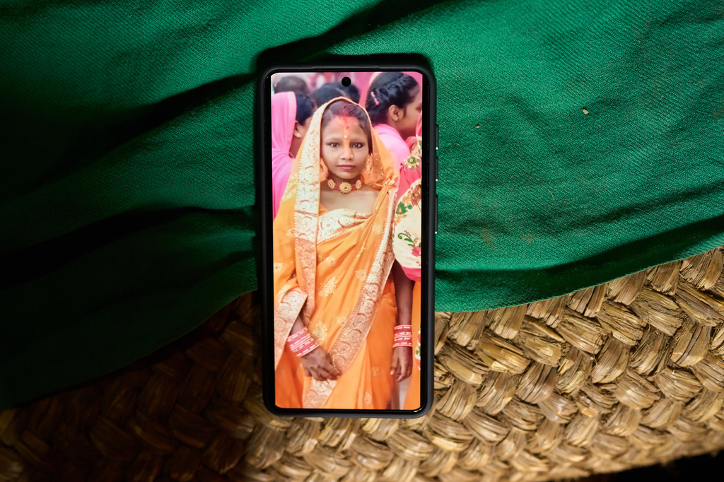 A photo of Kabita Mukhiya, who died during pregnancy, is displayed on a phone on May 19, 2026, in Gaur, Nepal. (AP Photo/Bram Janssen)