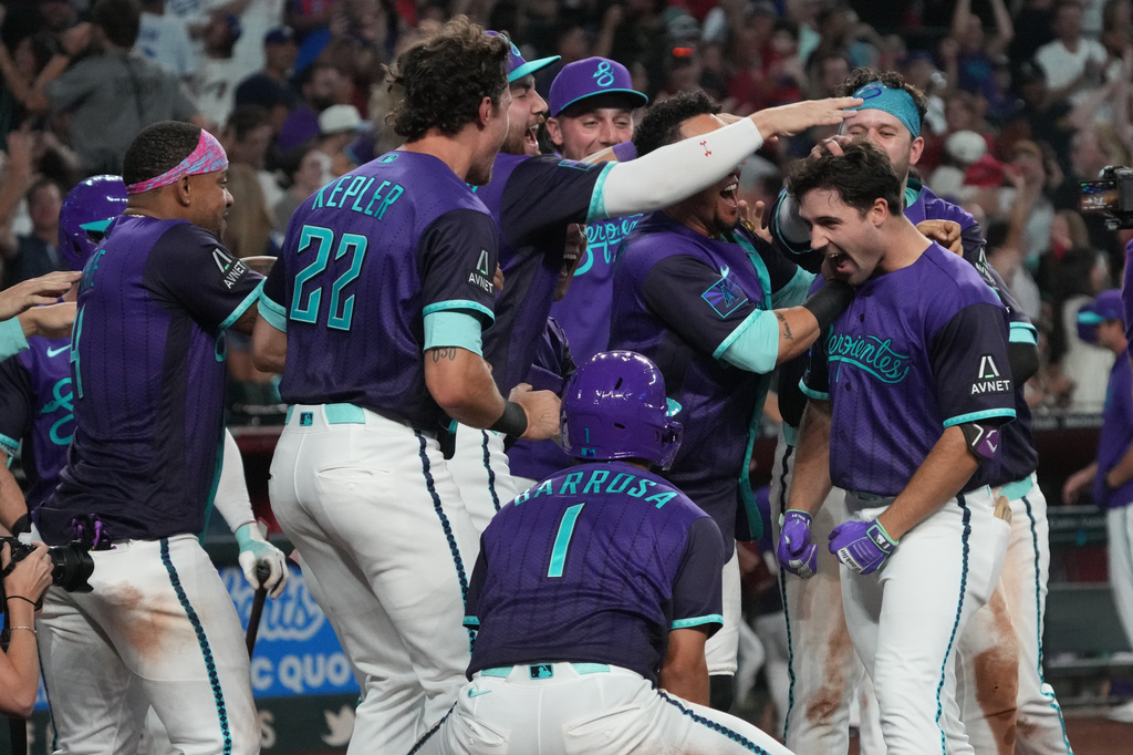 Arizona Diamondbacks' Ryan Waldschmidt celebrates with teammates after hitting a two-run walk off home run against the Los Angeles Dodgers during a baseball game, Friday, Aug 7, 2026, in Phoenix. (AP Photo/Rick Scuteri)