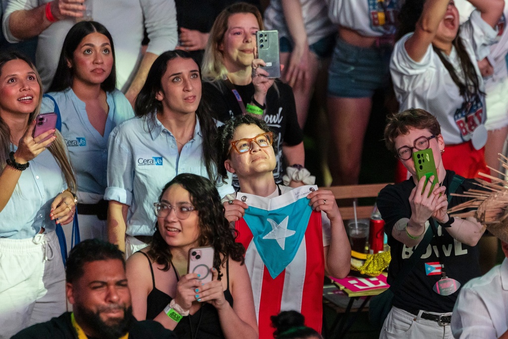 Fans in San Juan, Puerto Rico, watch Bad Bunny's performance on television during the halftime show of the NFL Super Bowl 60 football game Sunday, Feb. 8, 2026. (AP Photo/Alejandro Granadillo)