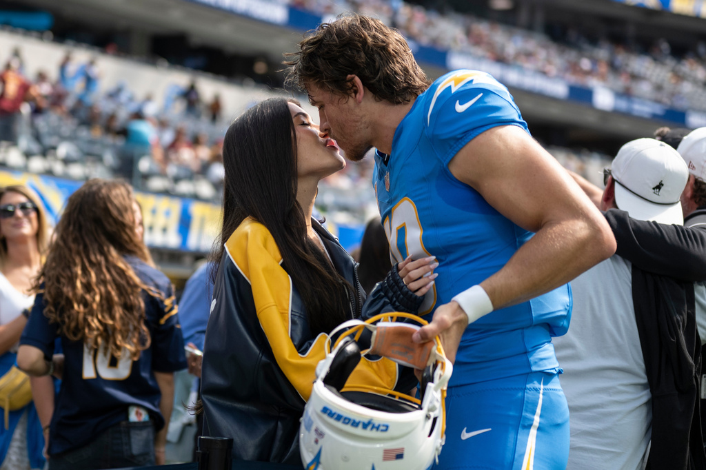 FILE - Los Angeles Chargers quarterback Justin Herbert, right, kisses Madison Beer before an NFL football game against the Washington Commanders, Sunday, Oct. 5, 2025, in Inglewood, Calif. (AP Photo/Kyusung Gong, File)