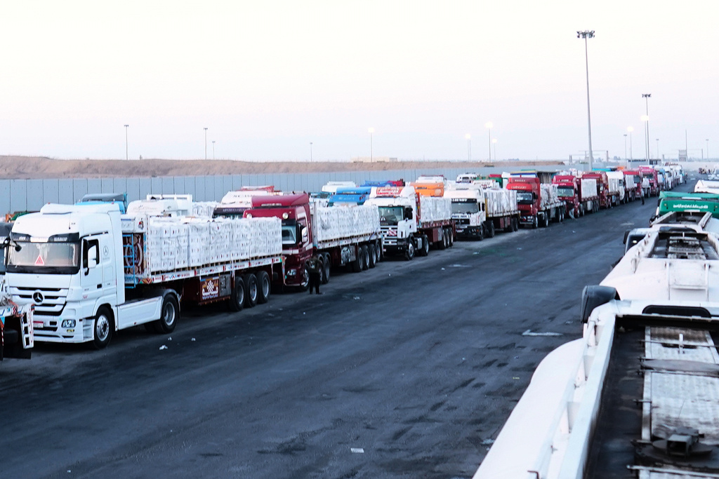 FILE -Trucks carrying humanitarian aids prepare to cross the Egyptian gate of the Rafah crossing, waiting for inspections by Israeli authorities before entering the Gaza Strip, following an agreement between Israel and Hamas on a ceasefire, Oct. 20, 2025. (AP Photo/Mohamed Arafat, File)