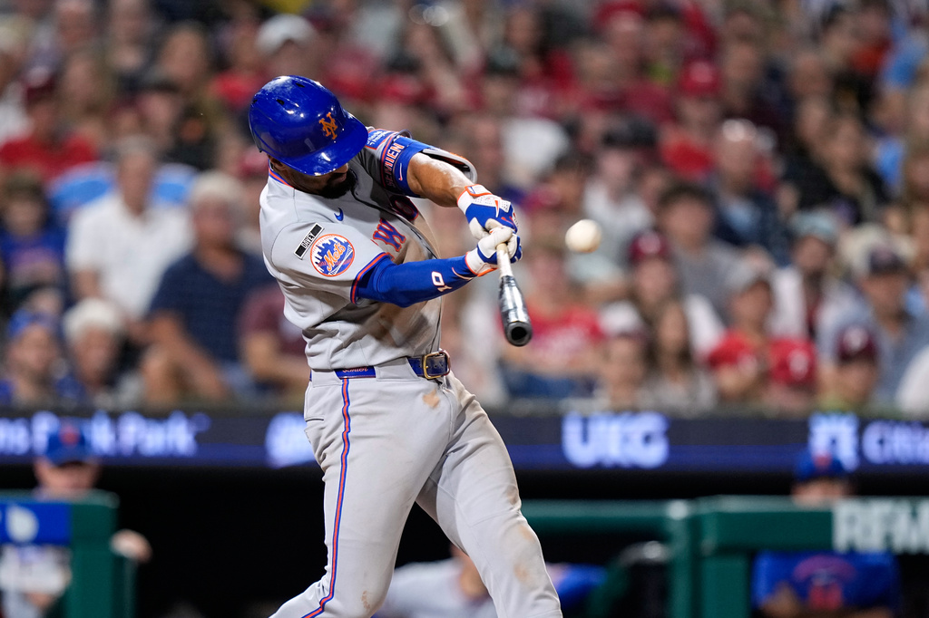 New York Mets' Marcus Semien hits a two-run triple against Philadelphia Phillies pitcher José Alvarado during the seventh inning of a baseball game Thursday, June 18, 2026, in Philadelphia. (AP Photo/Matt Slocum)