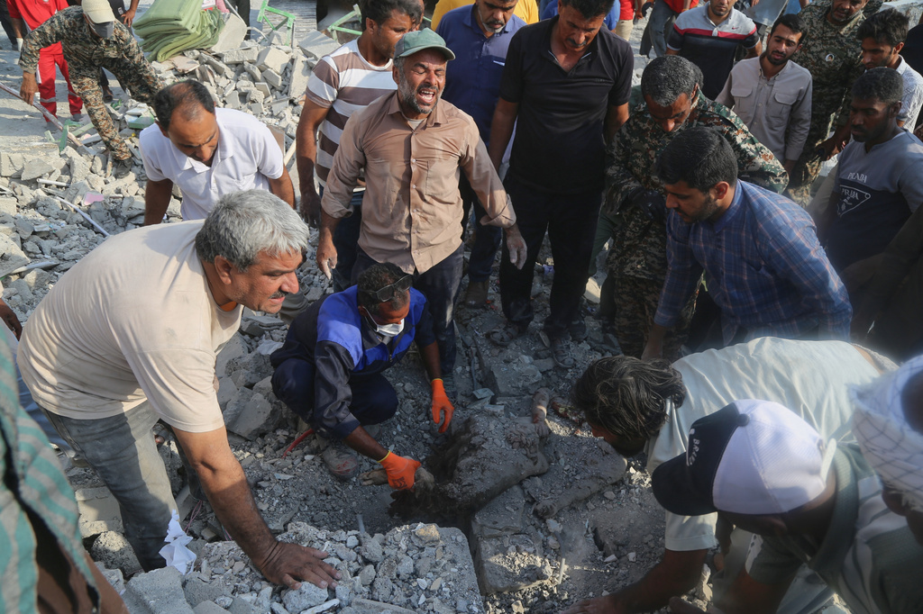 Rescue workers and residents search through the rubble in the aftermath of a strike on a girls' elementary school in Minab, Iran, Saturday, Feb. 28, 2026. (Abbas Zakeri/Mehr News Agency via AP)