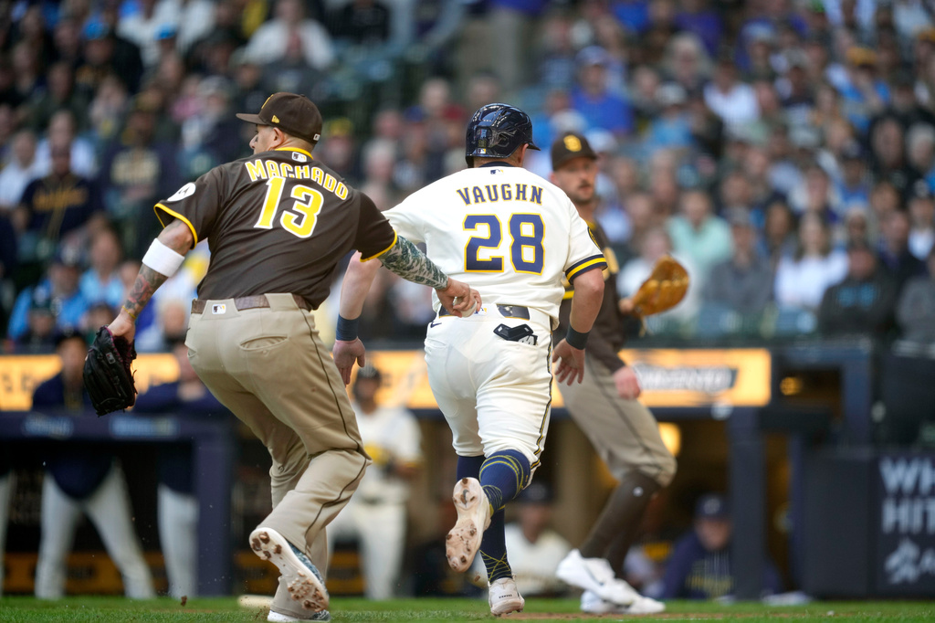 San Diego Padres third baseman Manny Machado (13) tags out Milwaukee Brewers' Andrew Vaughn (28) during the first inning of a baseball game, Thursday, May 14, 2026, in Milwaukee. (AP Photo/Kayla Wolf)