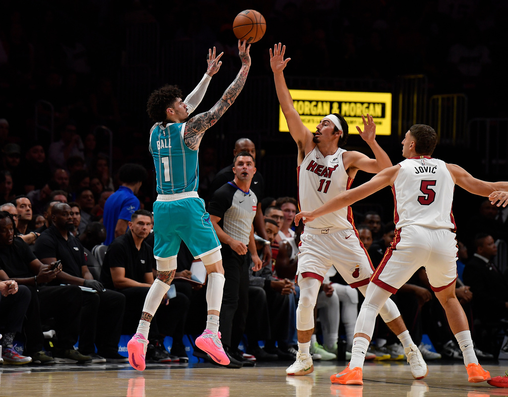 Charlotte Hornets guard Lamelo Ball (1) shoots over Miami Heat guard Jaime Jaquez Jr. (11) during the first half of an NBA basketball game, Tuesday, Oct. 28, 2025, in Miami. (AP Photo/Michael Laughlin)