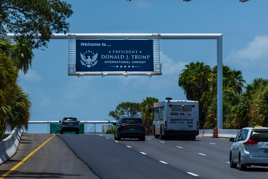 Airport visitors drive under a sign displaying the name of the rebranded Donald J. Trump International Airport in West Palm Beach, Fla., Thursday, July 9, 2026. (AP Photo/Saul Martinez)