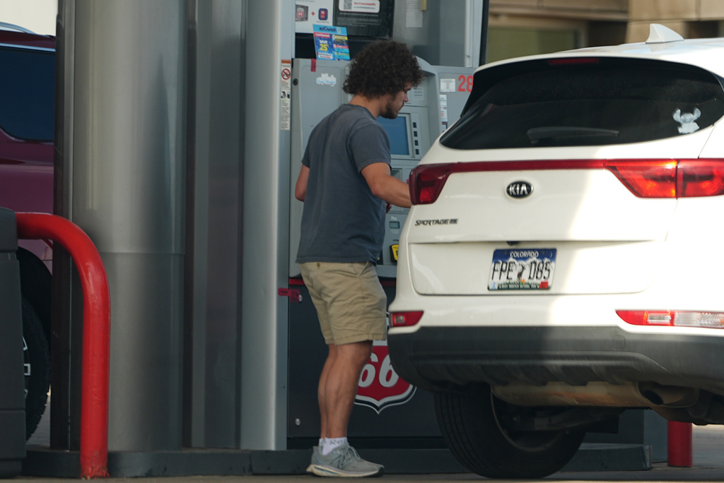 A motorist fills up the tank of a utility vehicle at a Phillips 66 gasoline station at Denver International Airport Saturday, May 9, 2026, in Denver. (AP Photo/David Zalubowski)