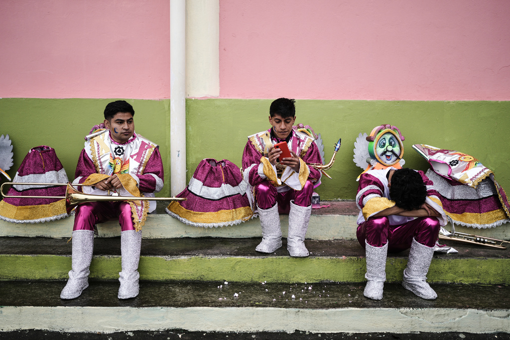 Revelers rest prior to the start of the Black and White Carnival, recognized by UNESCO as Intangible Cultural Heritage, in Pasto, Colombia, Tuesday, Jan. 6, 2026. (AP Photo/Ivan Valencia)