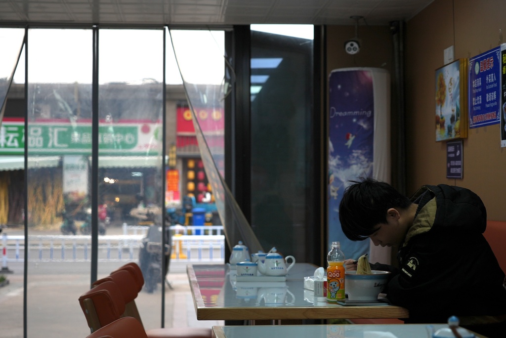 A resident dines on hand-pulled noodle soup at a restaurant in the semi-abandoned "Life in Venice" housing complex in Qidong, on China's east coast, Feb. 5, 2026. (AP Photo/Dake Kang)