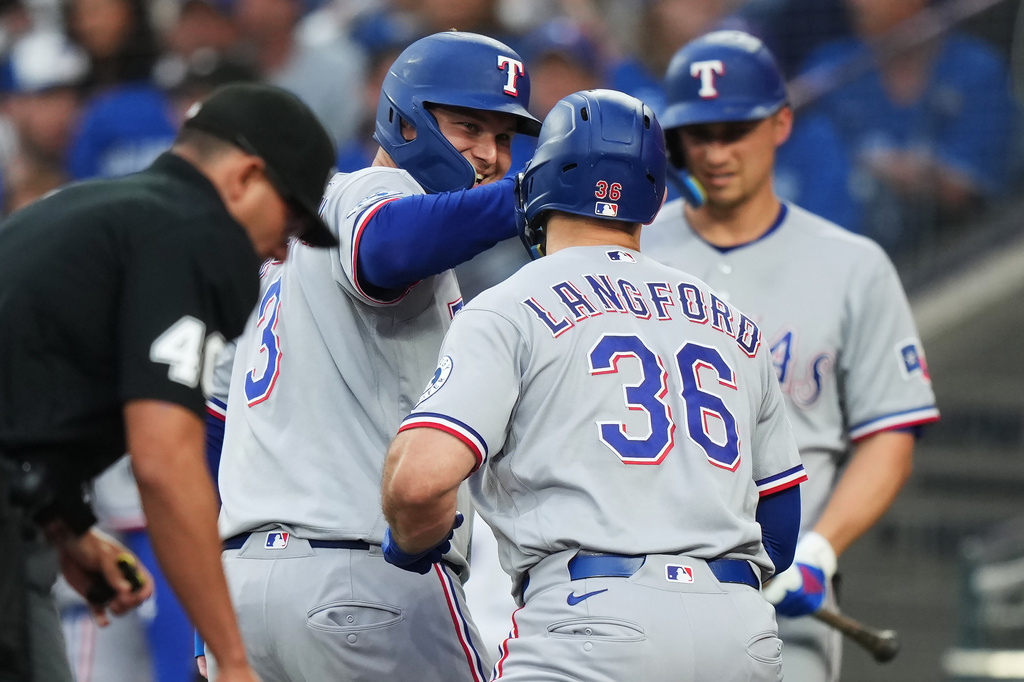 Texas Rangers' Wyatt Langford (36) celebrates his three-run home run against the Toronto Blue Jays with Joc Pederson (3) during the third of a baseball game in Toronto, Thursday, June 25, 2026. (Nathan Denette/The Canadian Press via AP)