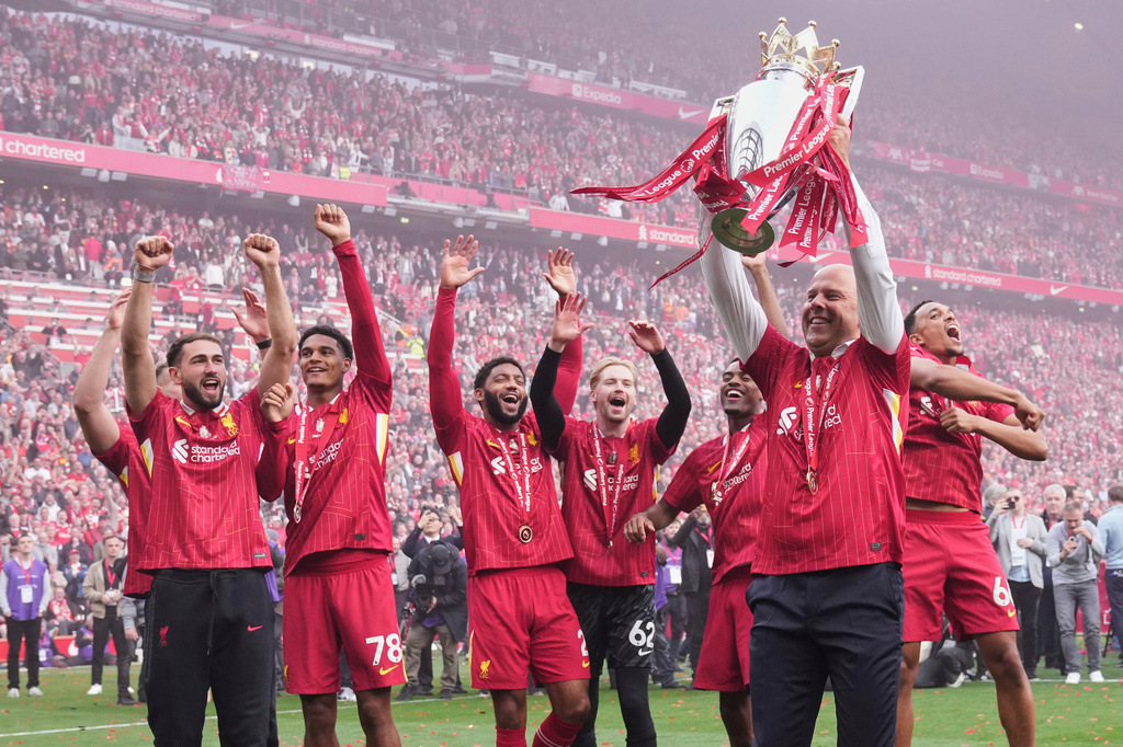 FILE - Liverpool's manager Arne Slot holds the winner's trophy as he celebrates with the players after the English Premier League soccer match between Liverpool and Crystal Palace at the Anfield stadium in Liverpool, England, Sunday, May 25, 2025. (AP Photo/Jon Super, File)