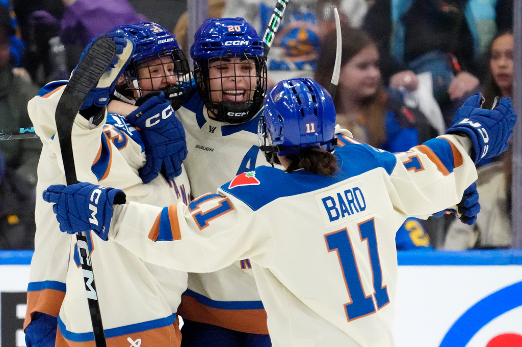 Vancouver Goldeneyes forward Sarah Nurse (20) celebrates after her goal with teammates Michelle Karvinen (33) and Sydney Bard (11) during second-period PWHL hockey game action against the Toronto Sceptres in Toronto, Saturday, Jan. 17, 2026. (Frank Gunn/The Canadian Press via AP)