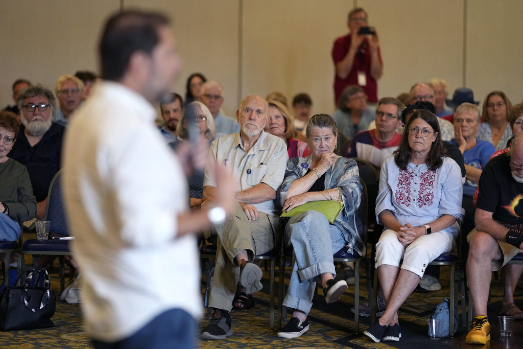 Audience members listen to Sen. Ruben Gallego, D-Ariz., speak during a town hall meeting, Saturday, Aug. 9, 2025, in Davenport, Iowa. (AP Photo/Charlie Neibergall)