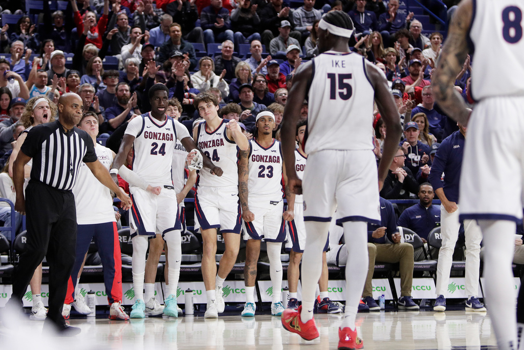 The Gonzaga bench celebrates forward Graham Ike (15) scoring a basket and drawing a foul during the second half of an NCAA college basketball game against Santa Clara, Thursday, Jan. 8, 2026, in Spokane, Wash. (AP Photo/Young Kwak)
