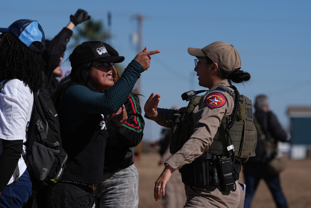 Protesters yell at a Texas state trooper outside the South Texas Family Residential Center detention facility where Liam Ramos and his father are being detained in Dilley, Texas, Wednesday, Jan. 28, 2026. (AP Photo/Eric Gay)