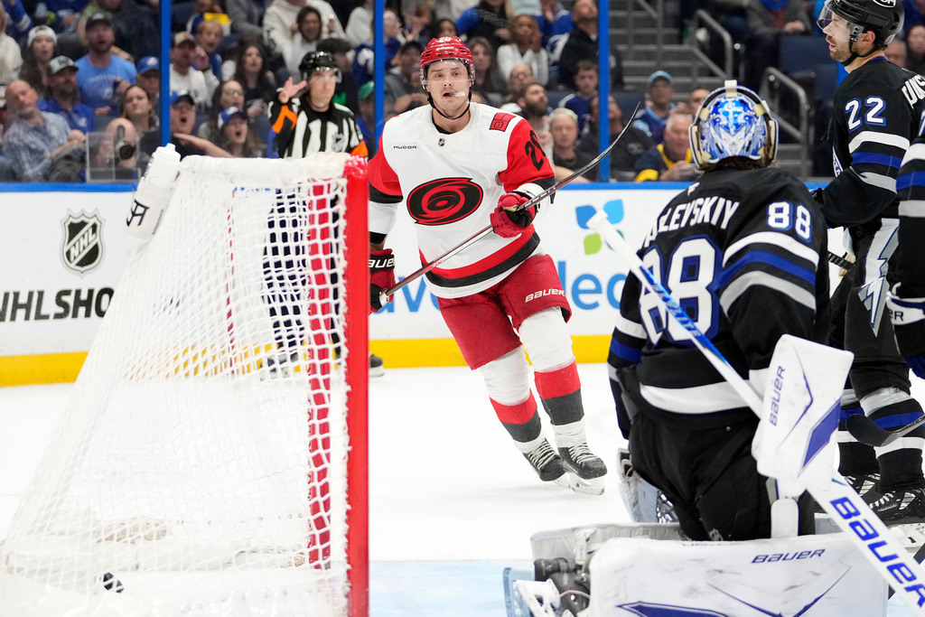 Carolina Hurricanes center Sebastian Aho (20) watches his shot get past Tampa Bay Lightning goaltender Andrei Vasilevskiy (88) for a goal during the first period of an NHL hockey game Saturday, March 14, 2026, in Tampa, Fla. (AP Photo/Chris O'Meara)