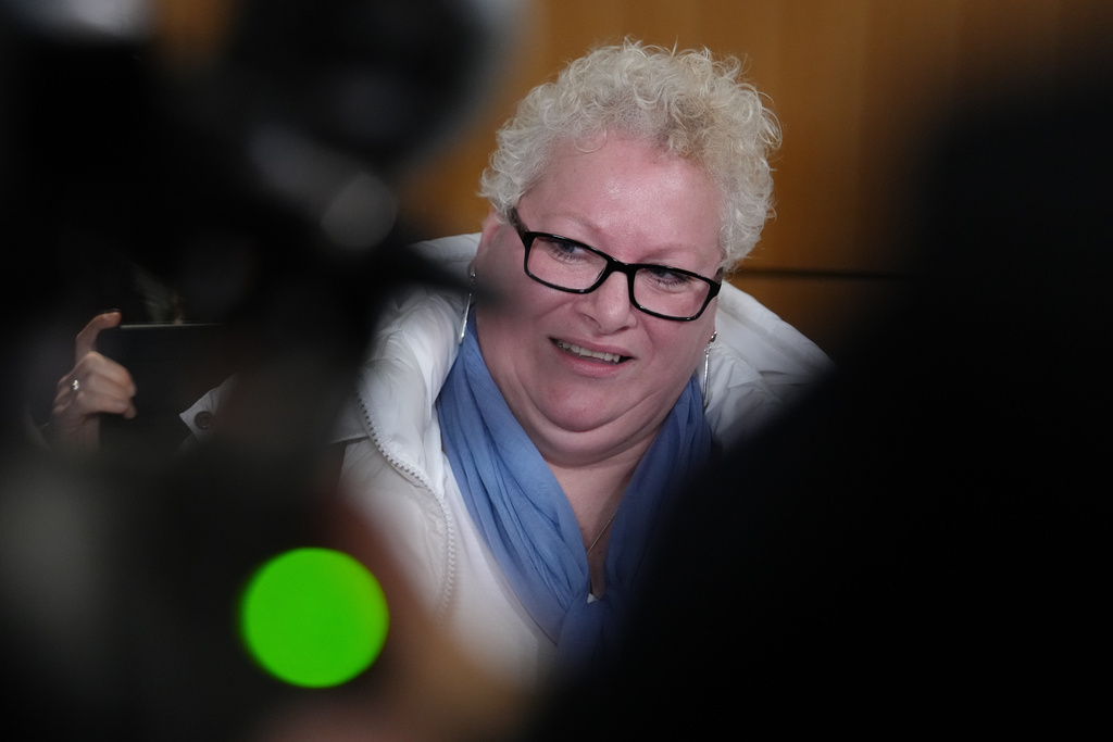 Defendant Delphine Jegousse known as Amandine Roy, answers reporters after a Paris court has found 10 people guilty of cyberbullying France's first lady, Brigitte Macron by spreading false online claims about her gender and sexuality, Monday, Jan. 5, 2026 in Paris. (AP Photo/Aurelien Morissard)