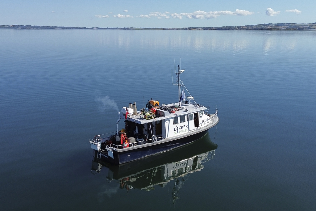 A diving vessel has anchored in Bay of Aarhus as a diver excavates an 8,500-year-old Stone Age coastal settlement below the Bay of Aarhus, Denmark. Aug.18, 2025. (AP Photo/James Brooks)