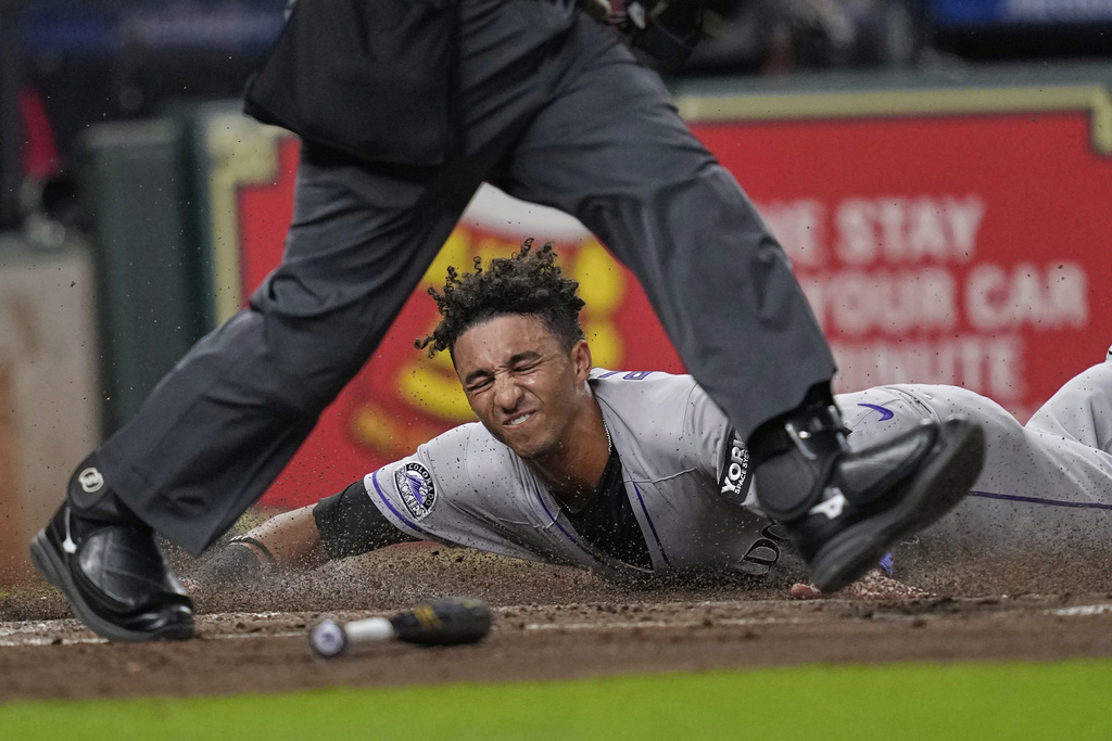 Colorado Rockies' Ryan Ritter scores against the Houston Astros during the third inning of a baseball game Tuesday, Aug. 26, 2025, in Houston. (AP Photo/David J. Phillip)