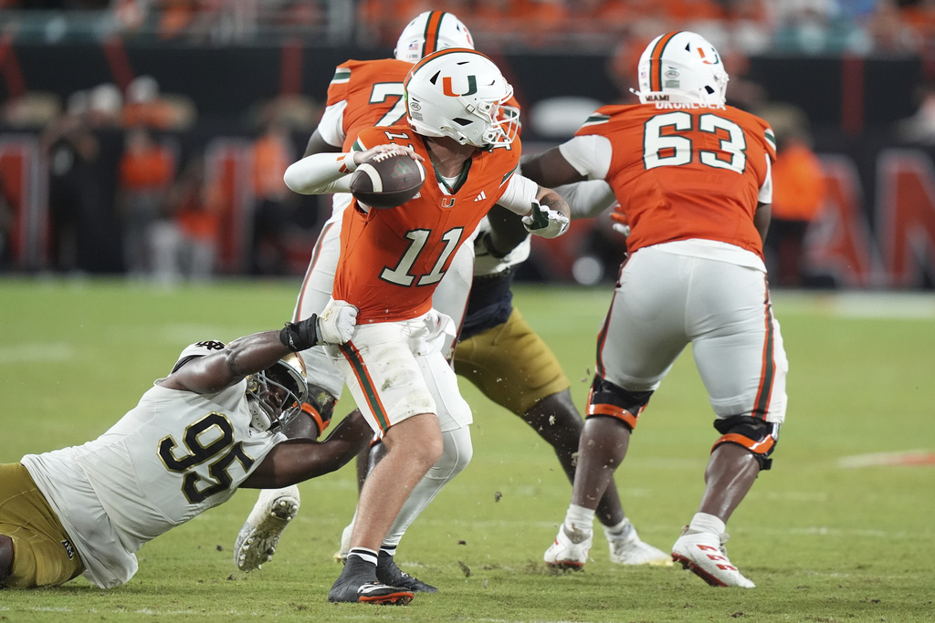 Notre Dame defensive lineman Bryce Young (95) pressures Miami quarterback Carson Beck (11) during the second half of an NCAA college football game, Sunday, Aug. 31, 2025, in Miami Gardens, Fla. (AP Photo/Lynne Sladky)