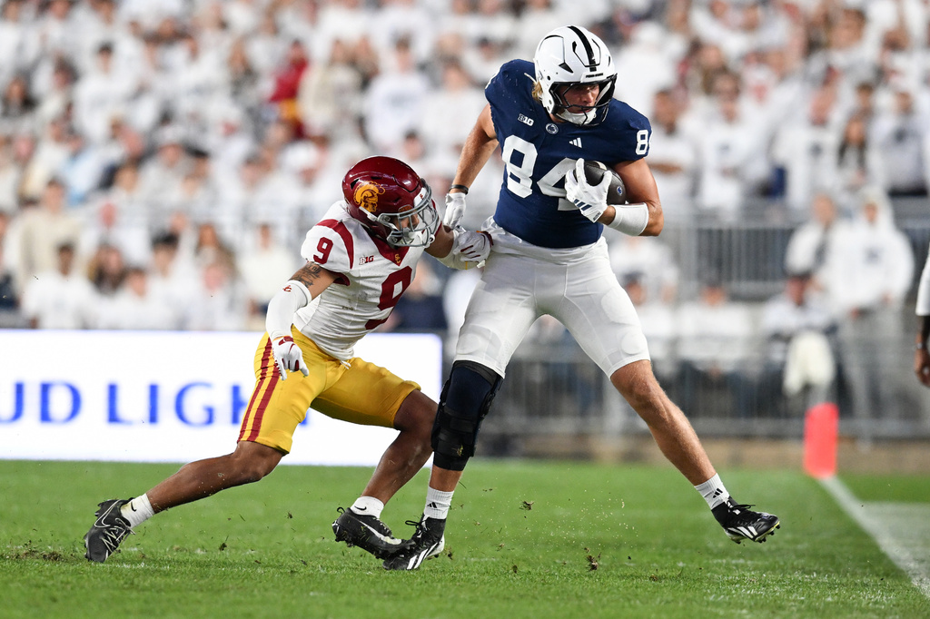 Southern California safety Kennedy Urlacher (9) tackles Penn State tight end Gabe Burkle (84) during the first half of an NCAA college football game, Saturday, Oct. 10, 2026, in State College, Pa. (AP Photo/Barry Reeger)