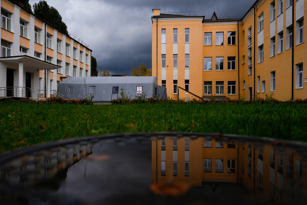 An invincibility point, which offers residents a place to charge devices, warm up, and rest on cots, is set up by an apartment complex during a rolling blackout, Thursday, Oct. 16, 2025, in Shostka, Ukraine. (AP Photo/Julia Demaree Nikhinson)