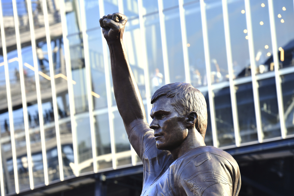 A bronze statue of former New England Patriots quarterback Tom Brady is unveiled in Patriot Place Plaza before an NFL preseason football game between the Washington Commanders and the New England Patriots Friday, Aug. 8, 2025, in Foxborough, Mass. (AP Photo/Steven Senne)