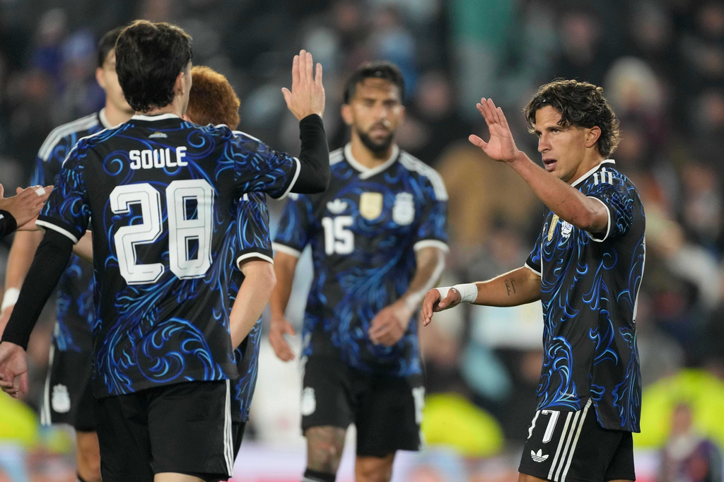 Argentina's Giuliano Simeone, right, celebrates with teammates after scoring his side's seventh goal against Burkina Faso during an international friendly soccer match in Buenos Aires, Argentina, Saturday, Oct. 3, 2026. (AP Photo/Gustavo Garello)