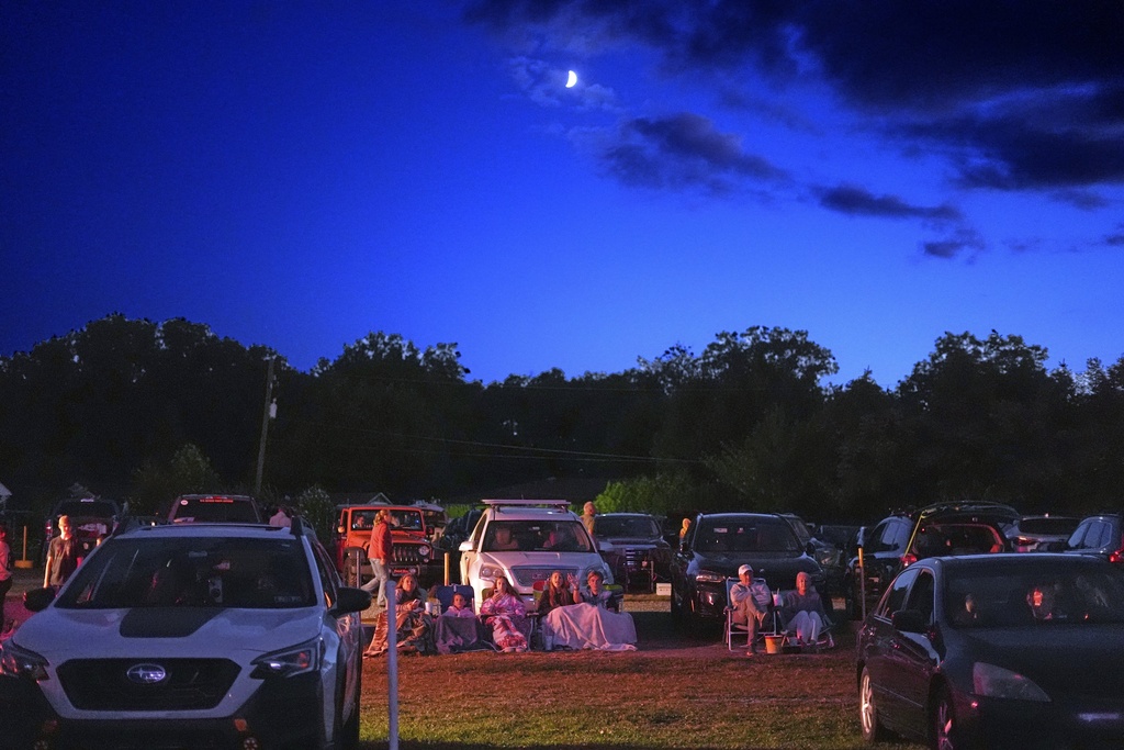 The Gambrill family, center, of Brookhaven, Pa., watch "Jaws" bundled up in front of their car at the Shankweiler Drive-In in Orefield, Pa., Friday, Aug. 29, 2025. (AP Photo/Gene J. Puskar)