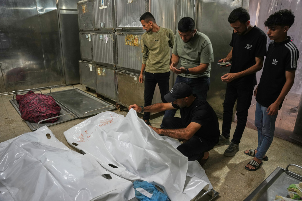 Mourners take the last look at the bodies of two Palestinian girls Zeina Safadi, and her sister Lana, who were killed during an overnight Israeli airstrike that damaged their home, during their funeral in Gaza city, Saturday, June 20, 2026. (AP Photo/Abdel Kareem Hana)