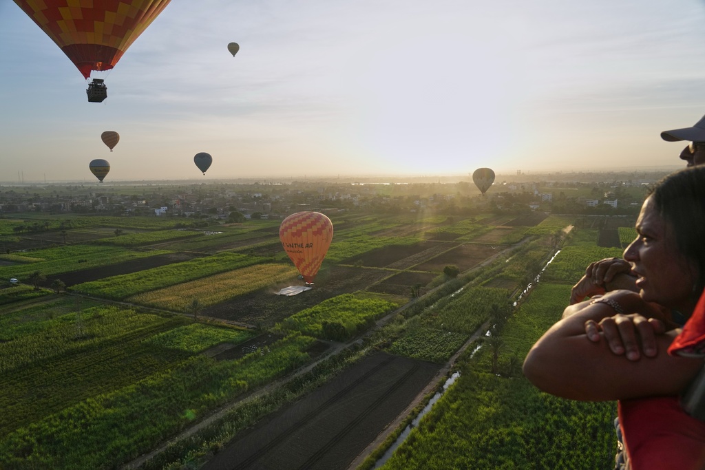 An Indian tourist views the city during their tour on a hot air balloon on the west bank of the Nile River in Luxor, Egypt, Oct. 4, 2025. (AP Photo/Amr Nabil)