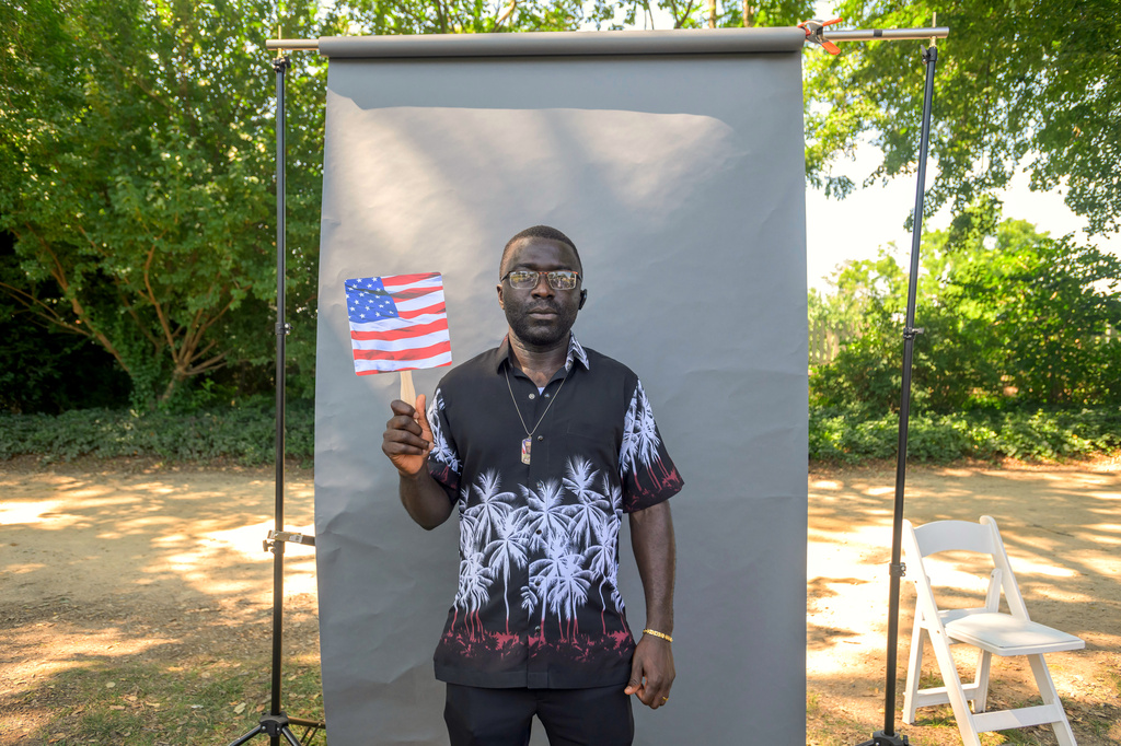 New U.S. citizen Tebid Munghey John-Paul, from Cameroon, poses for a portrait following a naturalization ceremony on Independence Day at George Washington's Mount Vernon, Saturday, July 4, 2026, in Alexandria, Va. (AP Photo/Rod Lamkey, Jr.)