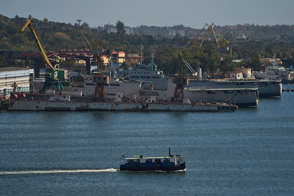 A ferry boat navigates across Havana Bay as it passes Cuban coast guard ships docked at the port as it leaves Casablanca, Cuba, Thursday, Feb. 26, 2026. (AP Photo/Ramon Espinosa)