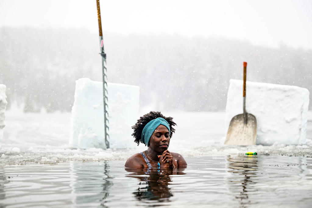 FILE - Canda-Leigh Habonimana dips in the waters of Gatineau Park's Meech Lake in Chelsea, Que., during a polar bear dip on New Year's Day, Jan. 1, 2025. (Justin Tang /The Canadian Press via AP)