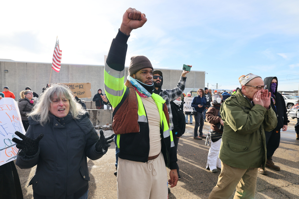 Protesters confront law enforcement outside the Bishop Henry Whipple Federal Building in Minneapolis, Friday, Jan. 9, 2026.(AP Photo/Adam Bettcher)