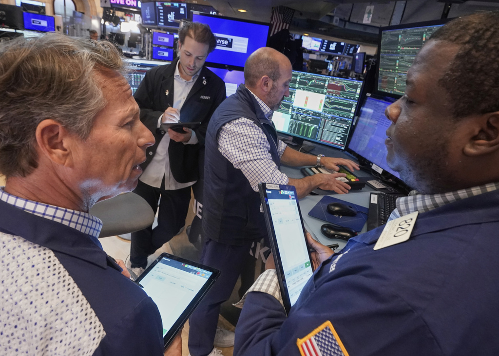 Traders Robert Charmak, left, Thomas Lee, right, and Ben Tuchman, background left, work with specialist James Denaro on the floor of the New York Stock Exchange, Friday, Sept. 5, 2025. (AP Photo/Richard Drew)