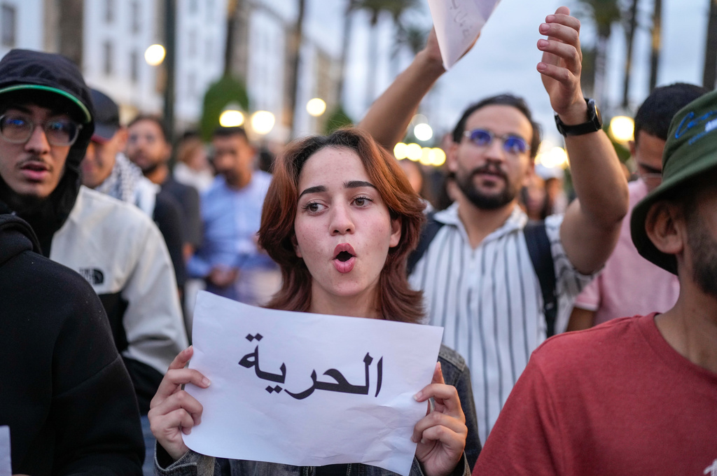 People take part in a youth-led protest against corruption and calling for education and healthcare reforms, in Rabat, Morocco, Thursday, Oct. 9, 2025. Banner in Arabic reads "Freedom". (AP Photo/Mosa'ab Elshamy)