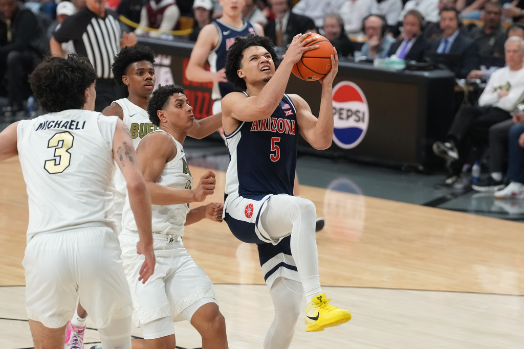 Arizona guard Brayden Burries, right, drives to the rim past Colorado guard Jalin Holland, center, and forward Alon Michaeli in the first half of an NCAA college basketball game Saturday, March 7, 2026, in Boulder, Colo. (AP Photo/David Zalubowski)