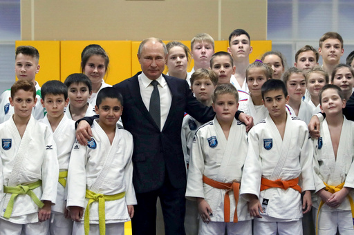 FILE - Russian President Vladimir Putin, poses for a photo during a visit to the judo club Turbostroitel leading by coach Anatoly Rakhlin when Putin was a boy in St. Petersburg, Russia, Wednesday, Nov. 27, 2019. (Mikhail Klimentyev, Sputnik, Kremlin Pool Photo via AP, File) FILE - Russian President Vladimir Putin, poses for a photo during a visit to the judo club Turbostroitel leading by coach Anatoly Rakhlin when Putin was a boy in St. Petersburg, Russia, Wednesday, Nov. 27, 2019. (Mikhail Klimentyev, Sputnik, Kremlin Pool Photo via AP, File)