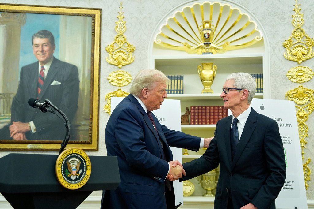 FILE - President Donald Trump shakes hands with Apple CEO Tim Cook in the Oval Office, Aug. 6, 2025, in Washington. (AP Photo/Alex Brandon, File)