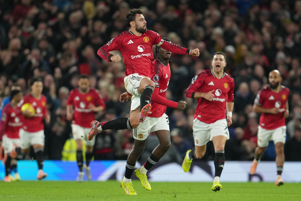 Manchester United's Bruno Fernandes celebrates after scoring during a Premier League soccer match between Manchester United and Bournemouth in Manchester, England, Monday, Dec. 15, 2025. (AP Photo/Jon Super)
