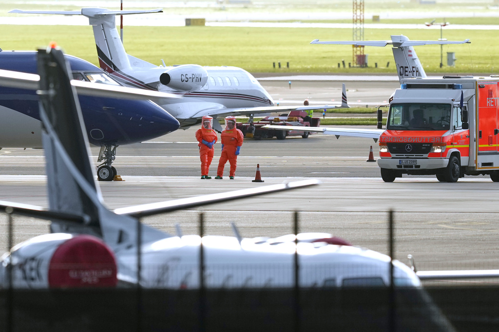 Medical personnel in hazmat suits wait for patients, evacuated from the MV Hondius cruise ship with suspected hantavirus infection, at Schiphol airport, Amsterdam, Netherlands, Wednesday, May 6, 2026. (AP Photo/Peter Dejong)