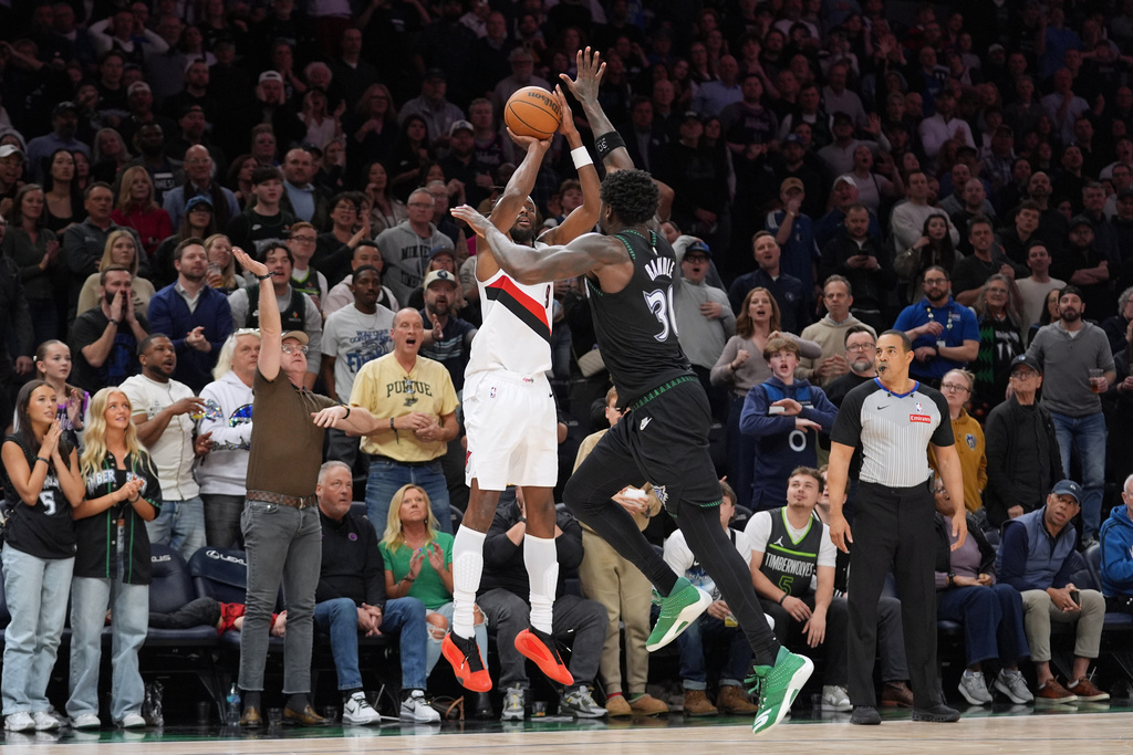 Portland Trail Blazers forward Jerami Grant (9) shoots over Minnesota Timberwolves forward Julius Randle (30) during the second half of an NBA basketball game Friday, March 20, 2026, in Minneapolis. (AP Photo/Abbie Parr)