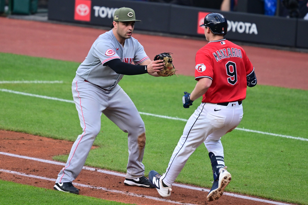 Cincinnati Reds first baseman Sal Stewart prepares to tag out Cleveland Guardians' Kyle Manzardo during the sixth inning of a baseball game, Saturday, May 16, 2026, in Cleveland. (AP Photo/David Dermer)