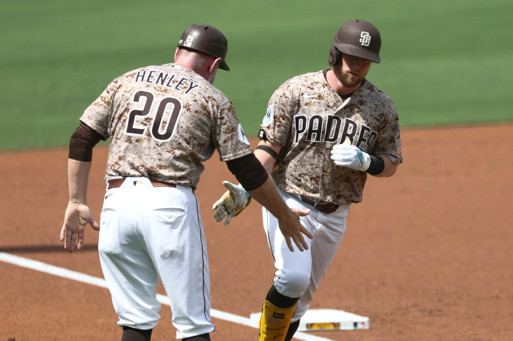San Diego Padres' Jake Cronenworth, right, celebrates with third base coach Bob Henley, left, after hitting a two-run home run in the second inning of a baseball game against the Miami Marlins, Sunday, Sept. 20, 2026, in San Diego. (AP Photo/Karl Anderson)