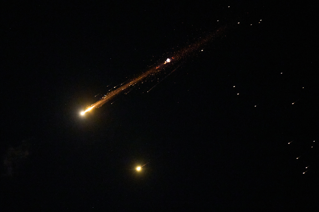 An Iranian cluster munition missile explodes in the sky over northern Israel, Wednesday, April 8, 2026. (AP Photo/Ariel Schalit)