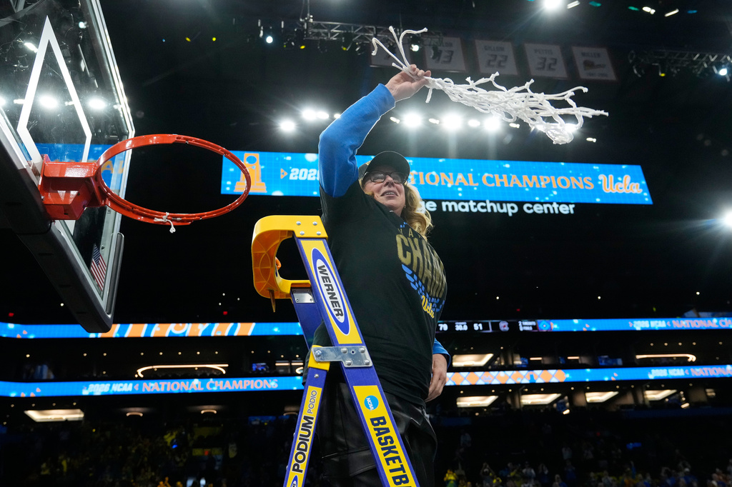 FILE - UCLA head coach Cori Close celebrates after cutting down the net after UCLA defeated South Carolina in the women's National Championship Final Four NCAA college basketball tournament game, April 5, 2026, in Phoenix. (AP Photo/Ross D. Franklin, File)