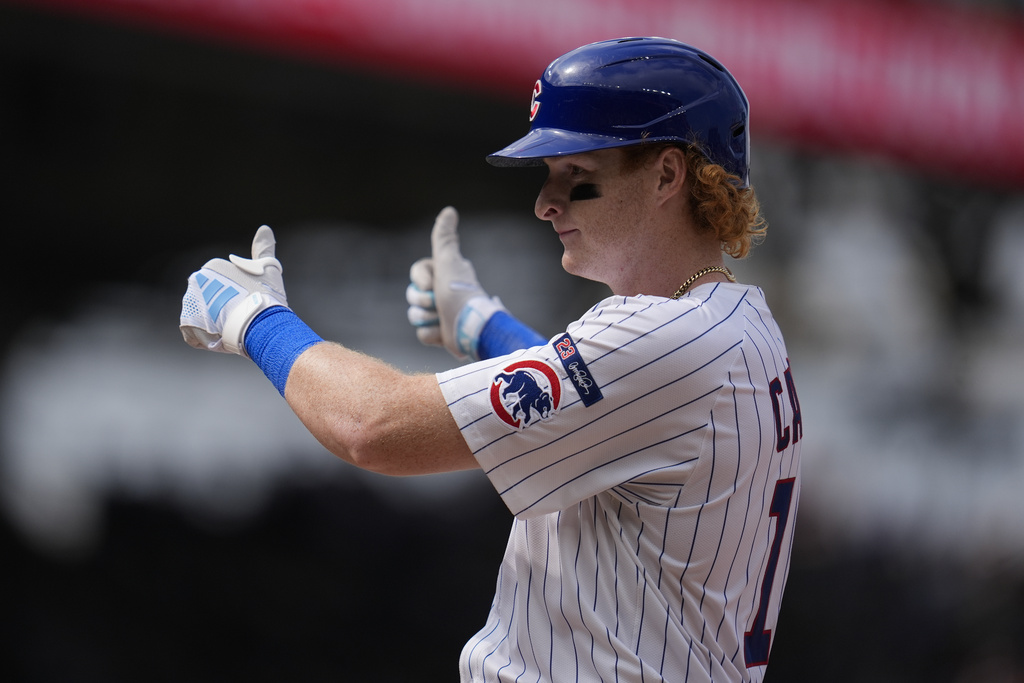 Chicago Cubs' Owen Caissie gives a thumbs-up to the dugout after hitting a single, his first major league hit, during the seventh inning of the first baseball game of a split doubleheader against the Milwaukee Brewers, Monday, Aug. 18, 2025, in Chicago. (AP Photo/Erin Hooley)